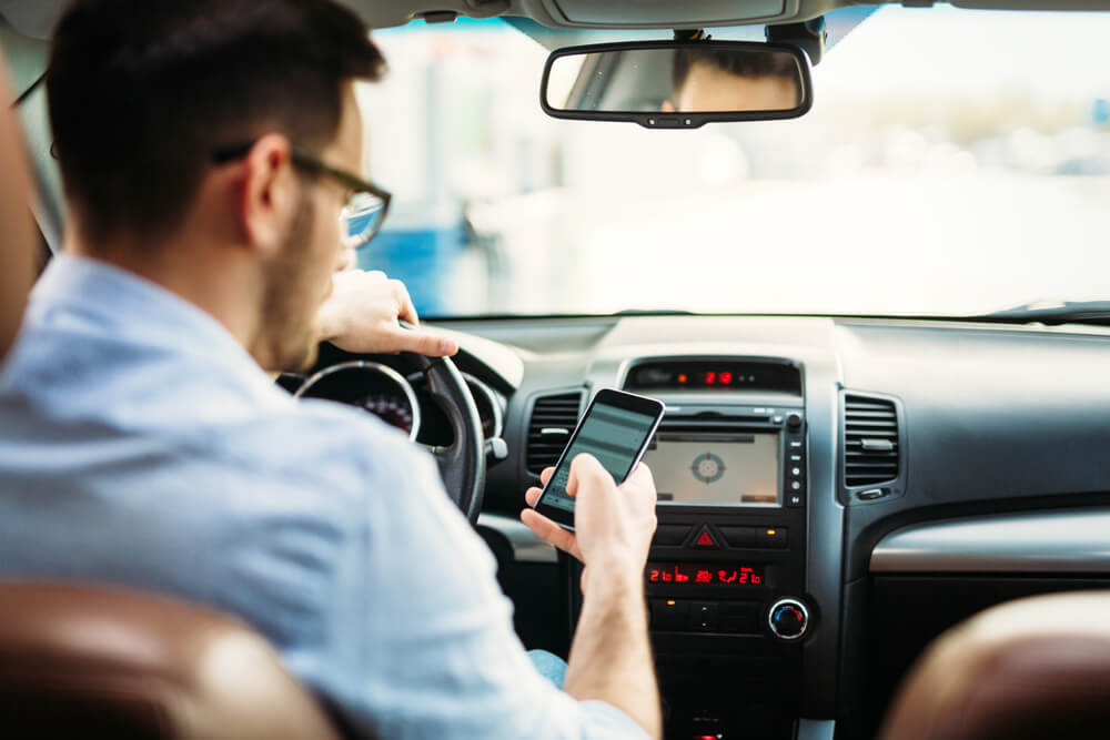 Driver is texting while driving.