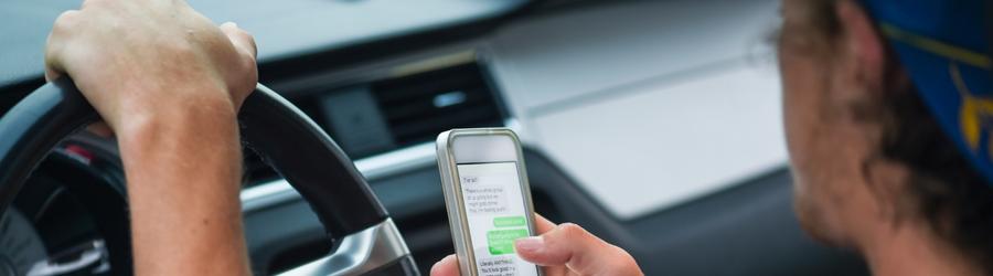 Man looking at his phone while driving