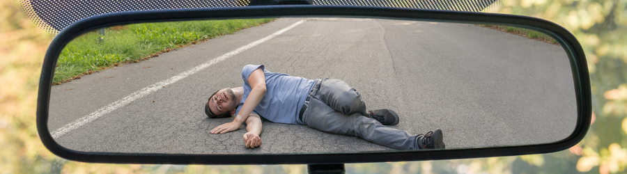 man on a rearview mirror after hit by a car