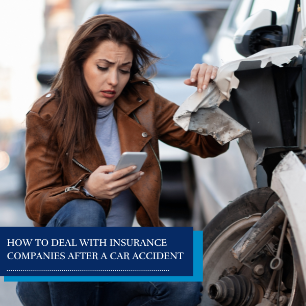 woman staring at her crashed car - how to deal with insurance companies after a car accident
